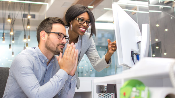 Man and woman go through benefits enrollment on a benefits technology tool